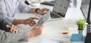 young-professional-ui-web-developer-working-on-his-project-with-laptop-computer-and-tablet - Gigabajt - komputery